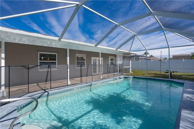 view of pool with a fenced in pool, glass enclosure, a patio area, and fence