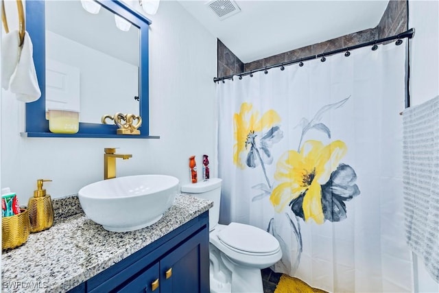 bathroom with vanity, toilet, and a shower with shower curtain