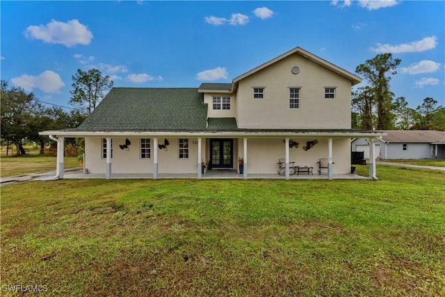 back of property with a patio and a lawn