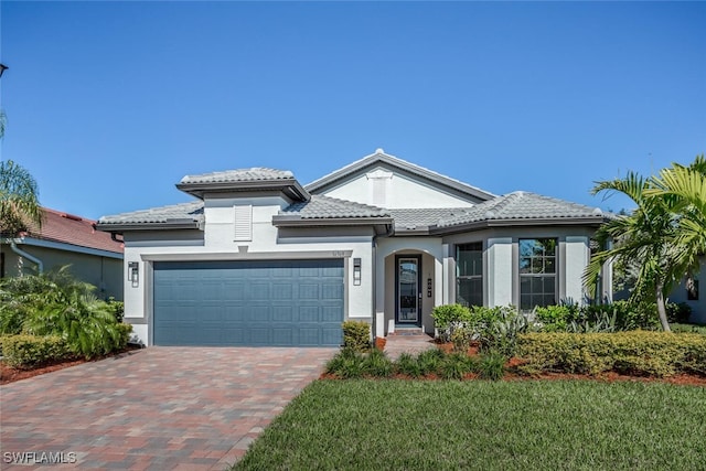 view of front of property featuring a garage and a front lawn