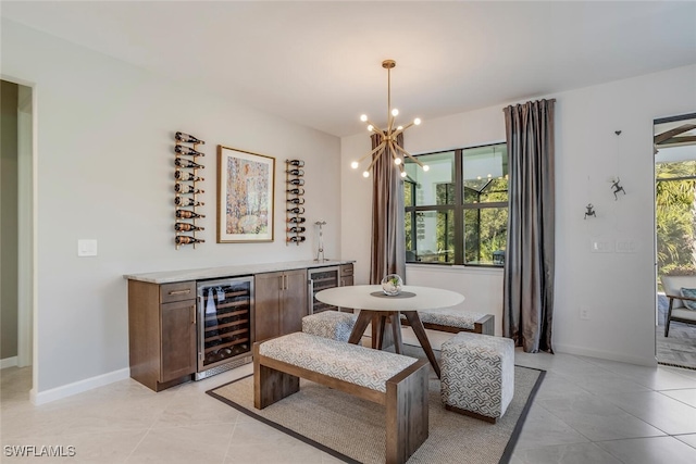 tiled dining space with beverage cooler and a chandelier