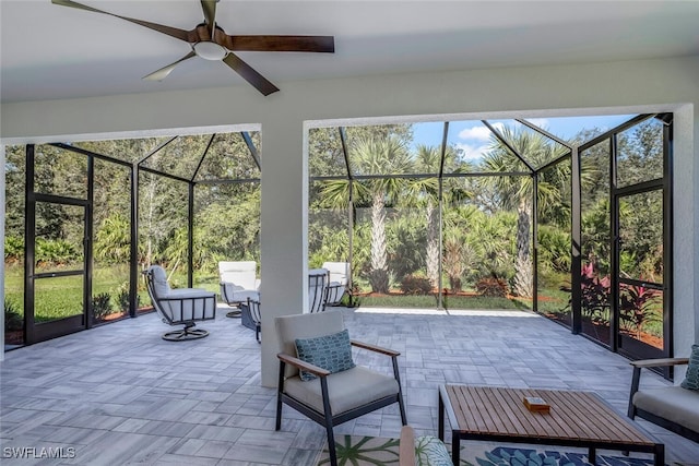 view of patio / terrace with ceiling fan and a lanai