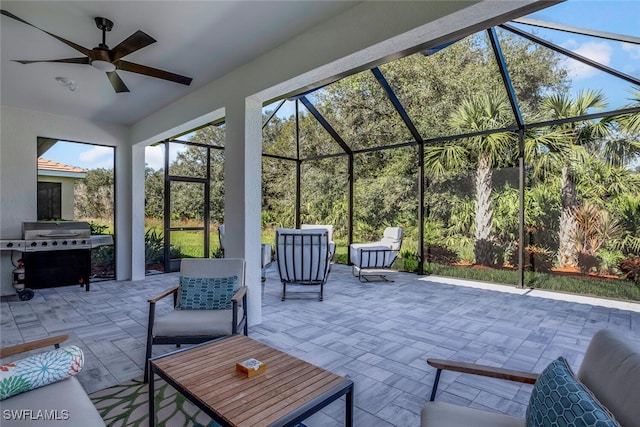 view of patio / terrace with ceiling fan, area for grilling, and a lanai