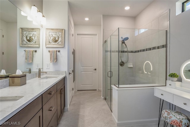 bathroom with vanity and a shower with door