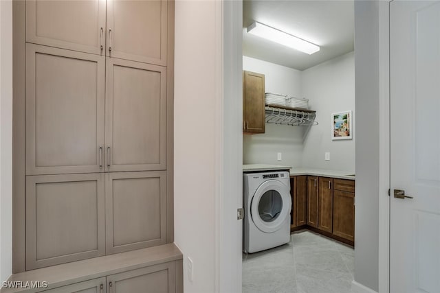 laundry room with washer / clothes dryer and cabinets