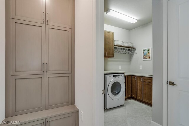 washroom featuring washer / clothes dryer and cabinets