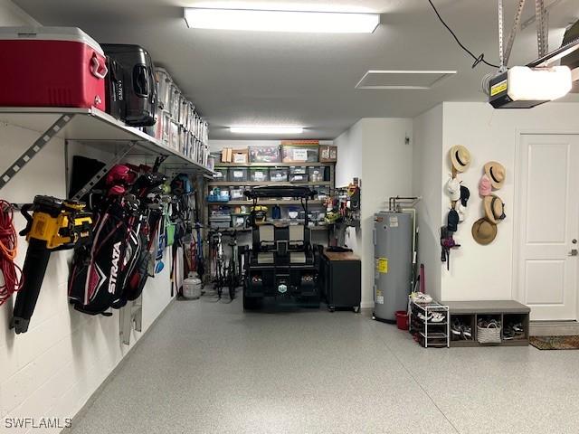 garage with water heater and a garage door opener