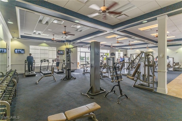 exercise room featuring ornate columns, a paneled ceiling, and ceiling fan