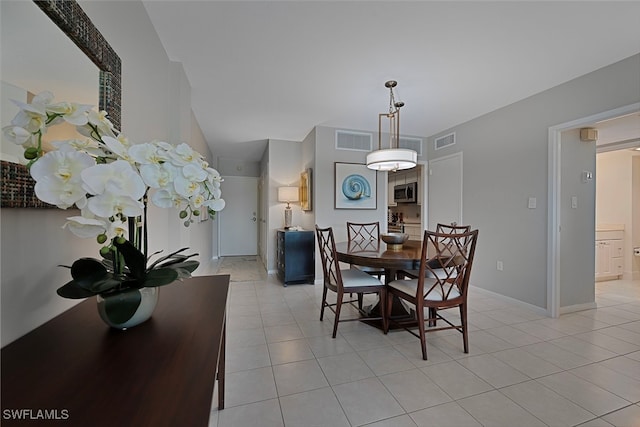 dining space featuring light tile patterned floors