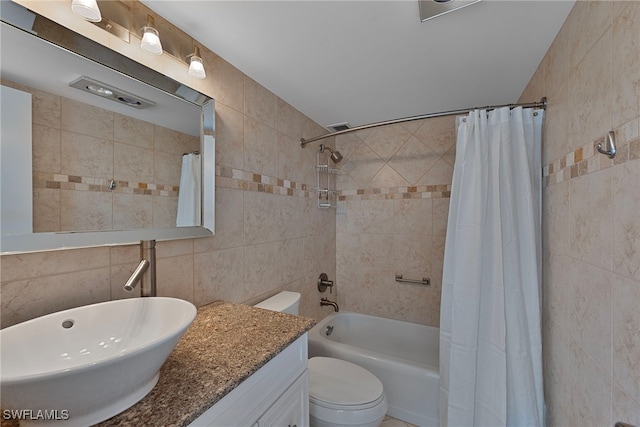 full bathroom featuring tile walls, vanity, toilet, and shower / tub combo with curtain