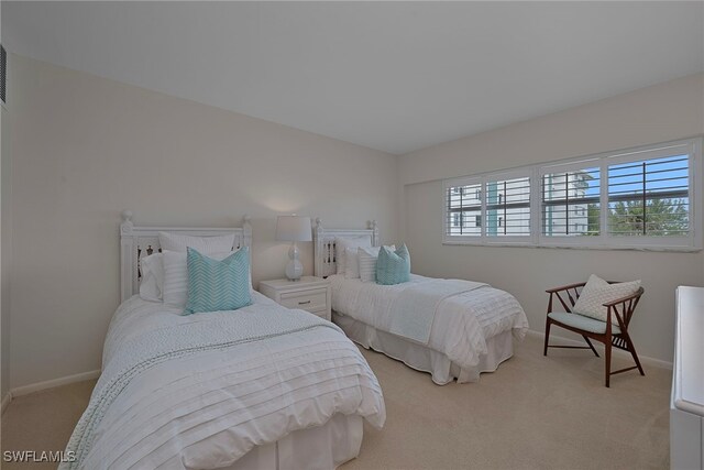 bedroom featuring multiple windows and light carpet