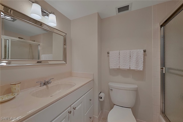 bathroom featuring walk in shower, vanity, and toilet