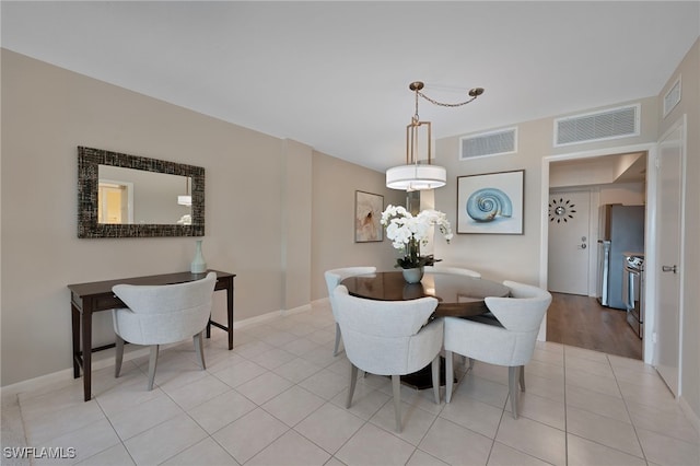 1977 Gulf Shore Blvd N Unit 306, Naples, FL 34102 - dining space with light tile patterned floors and baseboards