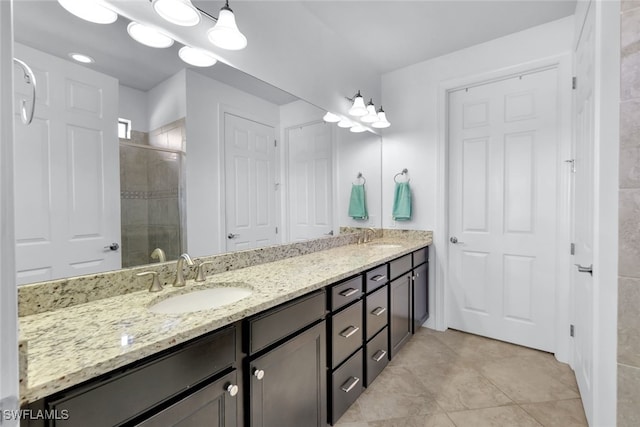 bathroom featuring vanity and a shower with door