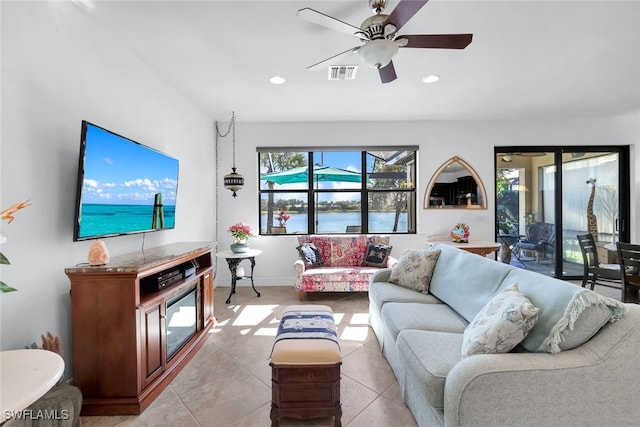 living room featuring light tile patterned floors and ceiling fan