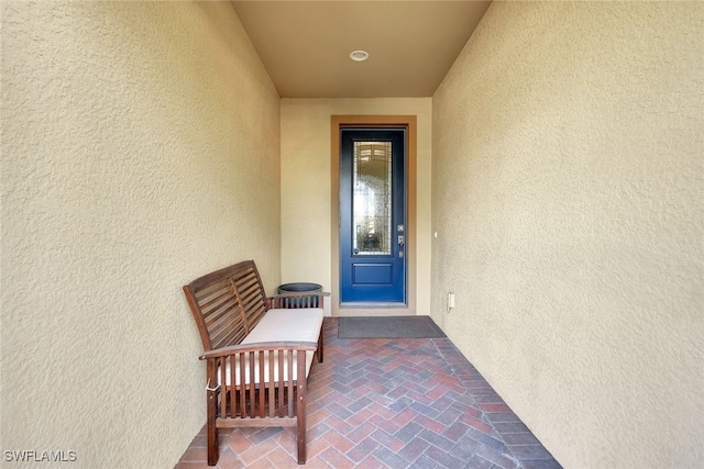 entrance to property with stucco siding