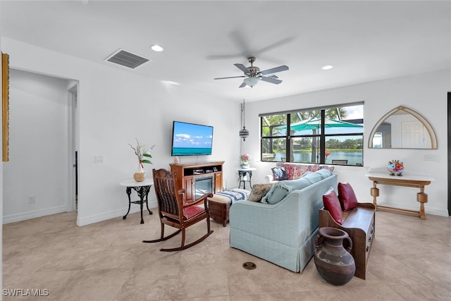 living area featuring baseboards, visible vents, and recessed lighting