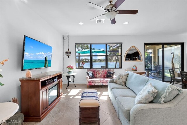 living area with a ceiling fan, recessed lighting, visible vents, and light tile patterned floors