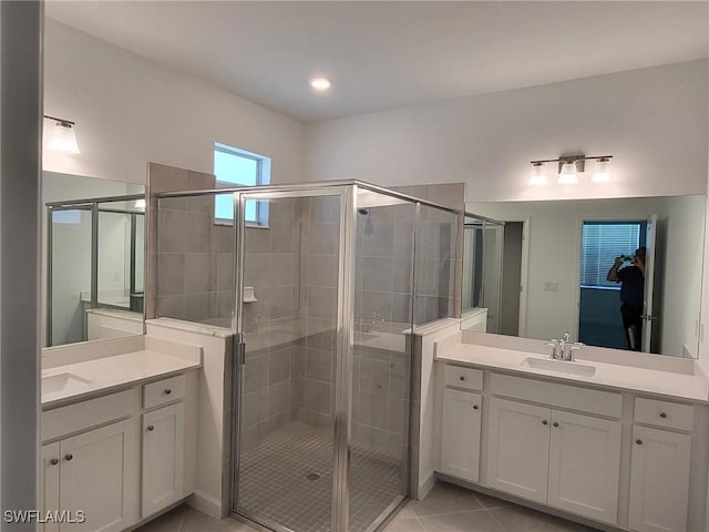 bathroom with tile patterned flooring, vanity, and an enclosed shower