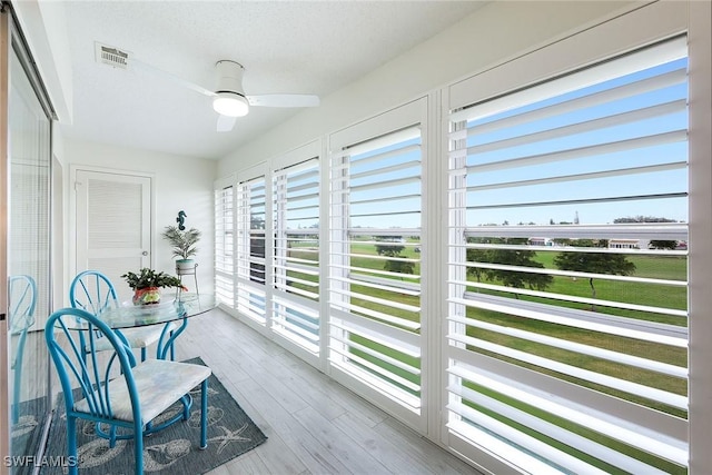 sunroom featuring ceiling fan