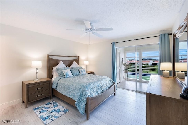 bedroom featuring ceiling fan, access to exterior, light hardwood / wood-style floors, and a textured ceiling