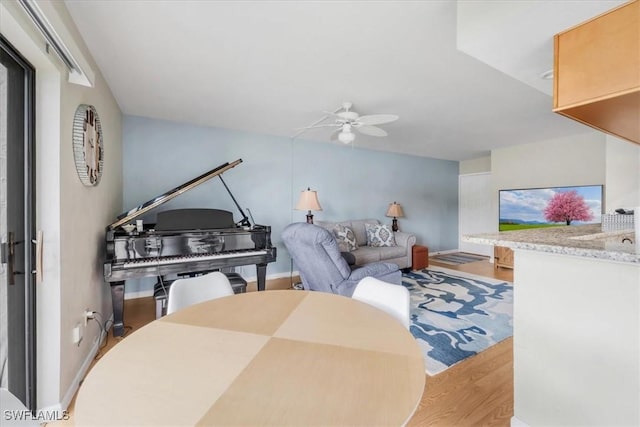 living room with ceiling fan and light wood-type flooring