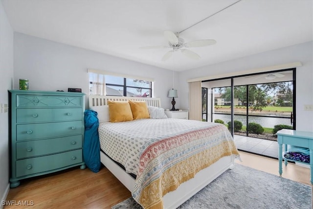 bedroom featuring access to exterior, light hardwood / wood-style flooring, and ceiling fan