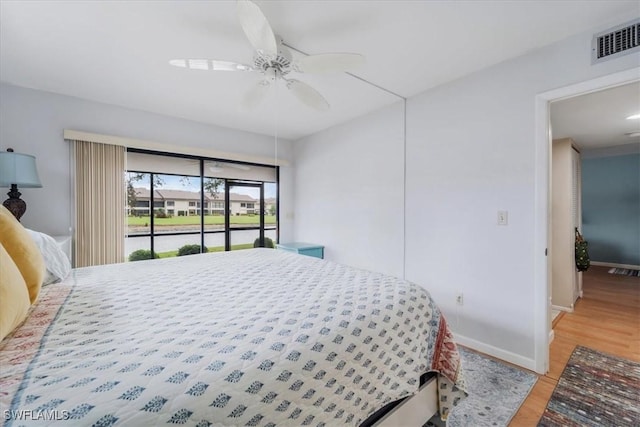 bedroom with ceiling fan, access to exterior, and light hardwood / wood-style floors