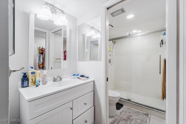 bathroom with vanity, toilet, and walk in shower