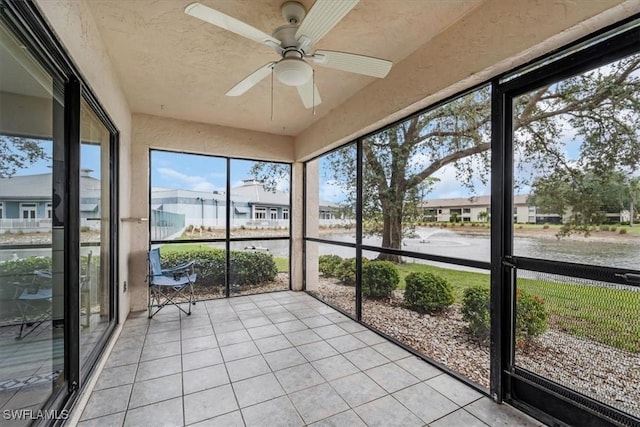 unfurnished sunroom with ceiling fan