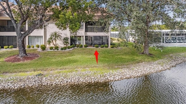 exterior space featuring a water view and a yard