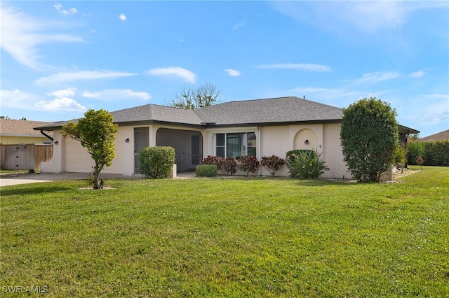 ranch-style house featuring a garage and a front yard