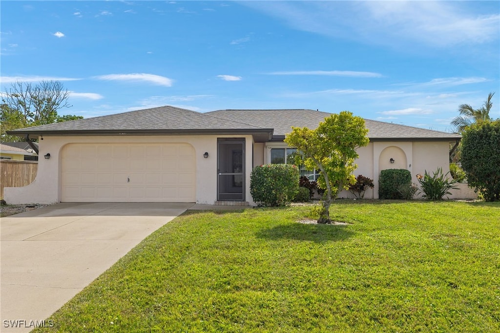 single story home featuring a garage and a front lawn