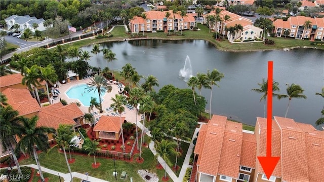 drone / aerial view featuring a residential view and a water view