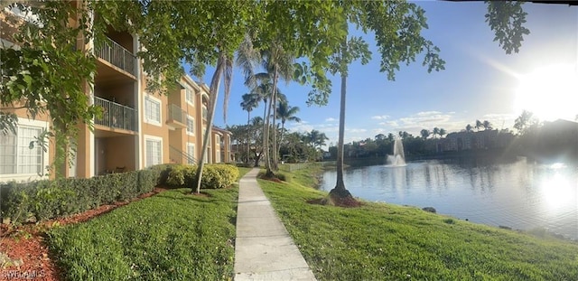 view of community with a water view and a lawn