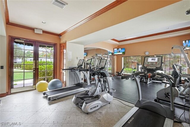 workout area with ornamental molding and french doors