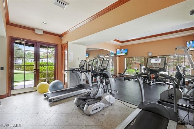 workout area with a healthy amount of sunlight, visible vents, and ornamental molding