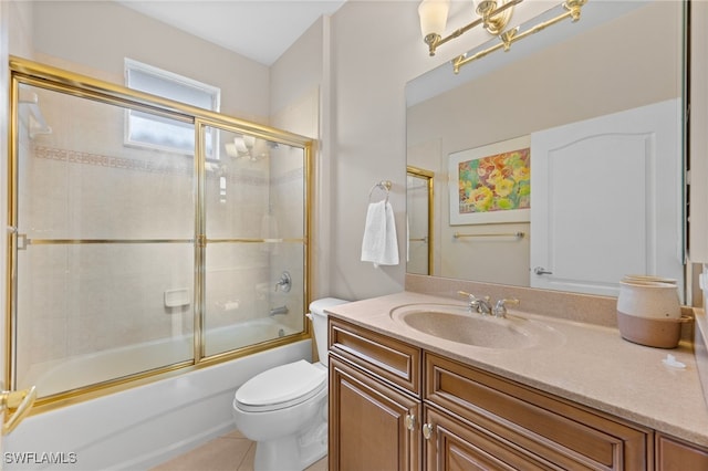 full bathroom featuring shower / bath combination with glass door, vanity, toilet, and tile patterned flooring