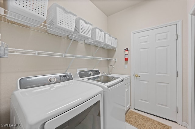 washroom with sink and washer and clothes dryer