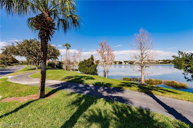 view of home's community featuring a water view and a yard