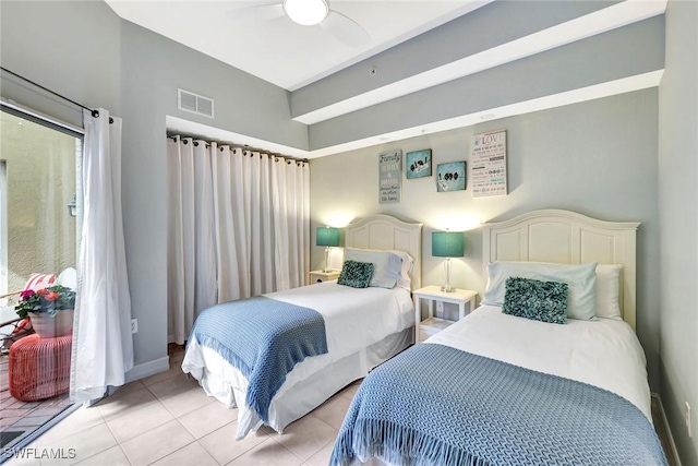 tiled bedroom featuring ceiling fan