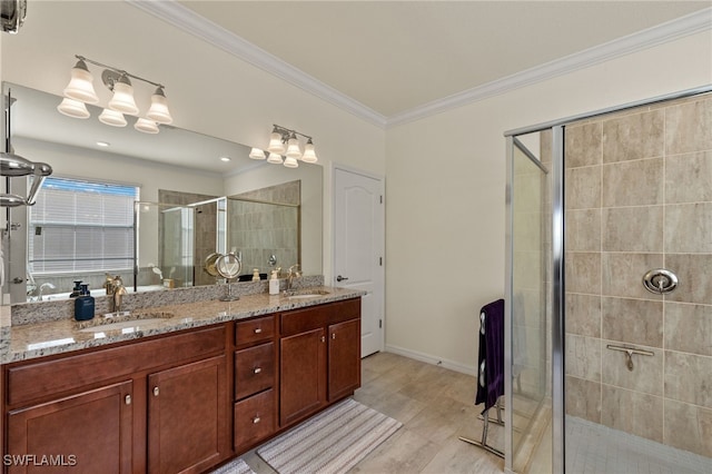 bathroom featuring vanity, crown molding, and walk in shower