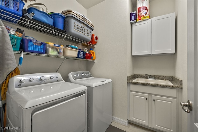 laundry room with sink, cabinets, and washer and dryer