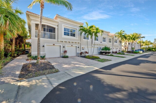 view of front of house with a garage and a balcony