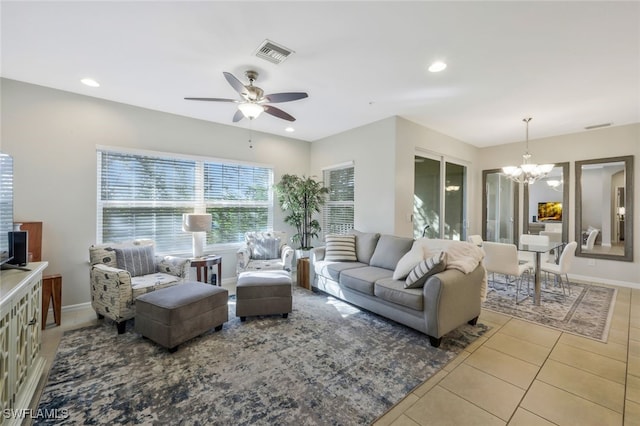 living room featuring tile patterned floors, visible vents, ceiling fan with notable chandelier, and recessed lighting