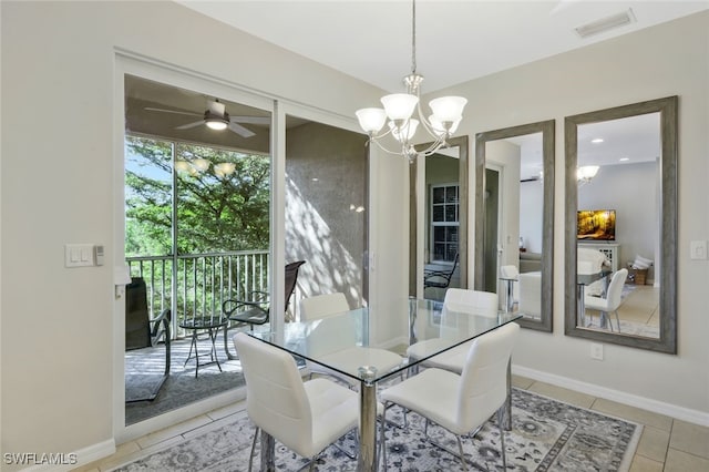 dining space with visible vents, baseboards, light tile patterned flooring, and ceiling fan with notable chandelier