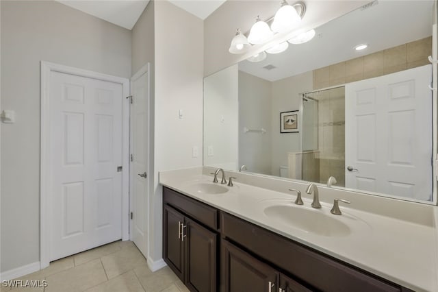 bathroom featuring vanity, toilet, tile patterned floors, and walk in shower