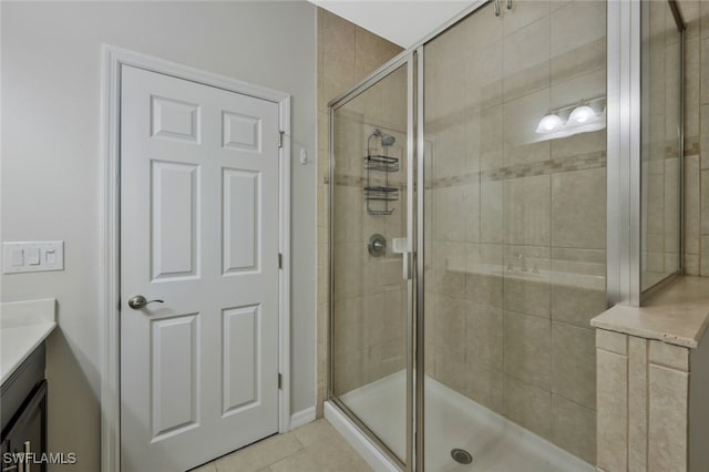 bathroom featuring vanity, a stall shower, and tile patterned flooring