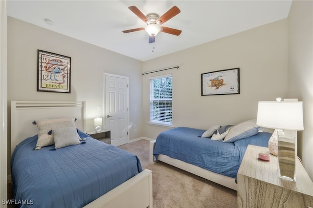 carpeted bedroom with baseboards and a ceiling fan