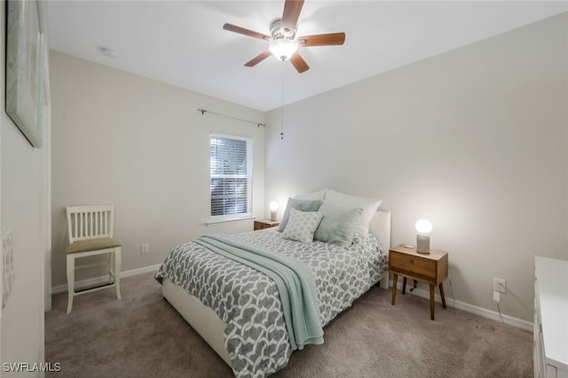 carpeted bedroom featuring baseboards and ceiling fan